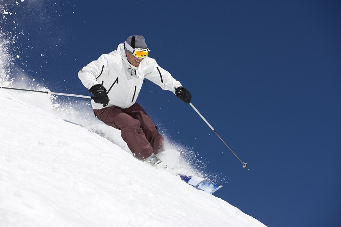 Man skiing with poles