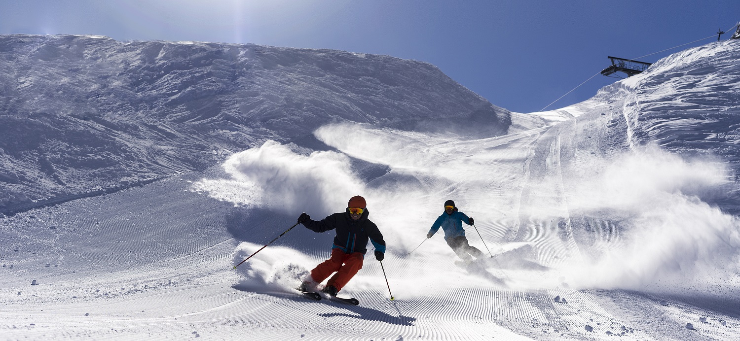 Two Skiers on a steep run