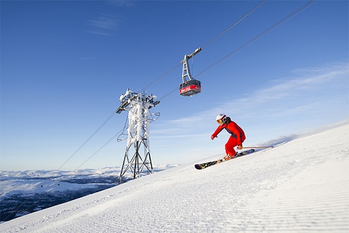 skier with cable car in the background