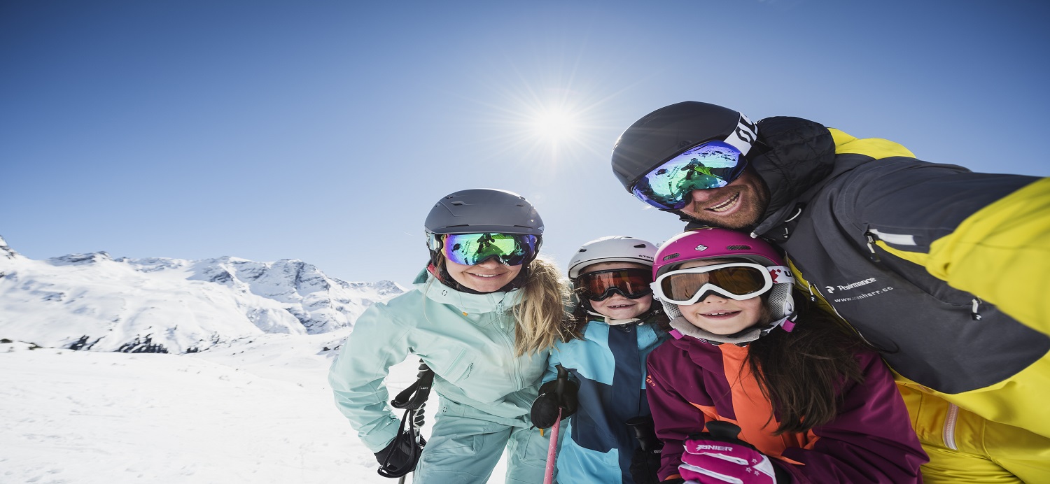 Smiling skiing family selfie