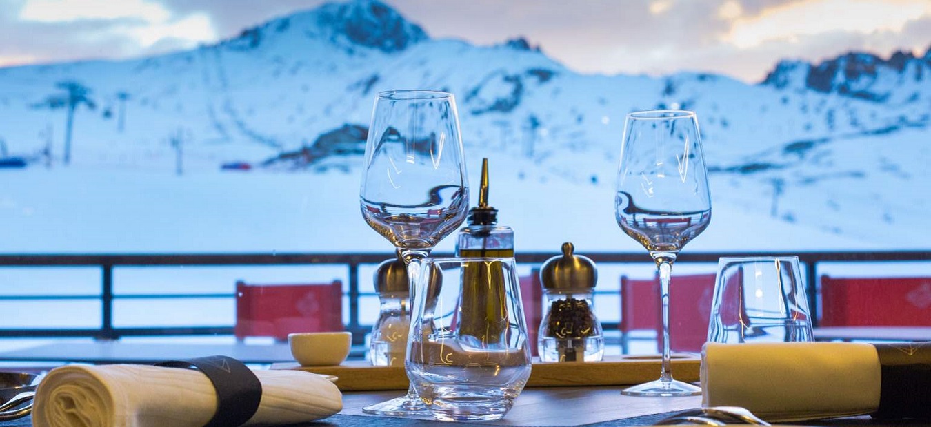 Restaurant table on a terrace with a mountain back drop