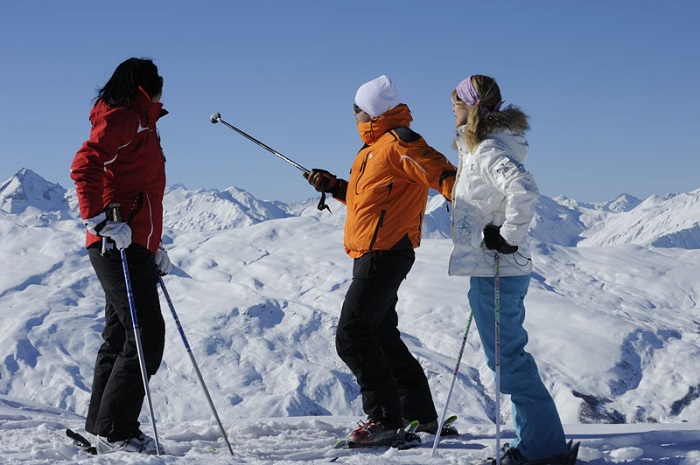 Corporate ski breaks with Skiweekends 3 skiers looking at a mountain view