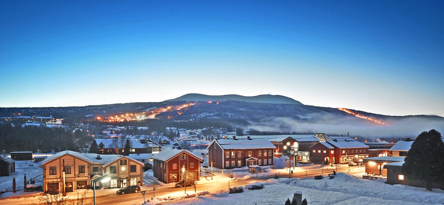 Scandinavian village with background ski slopes