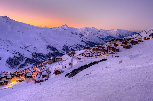 Ski resort in a valley with a purple sunset