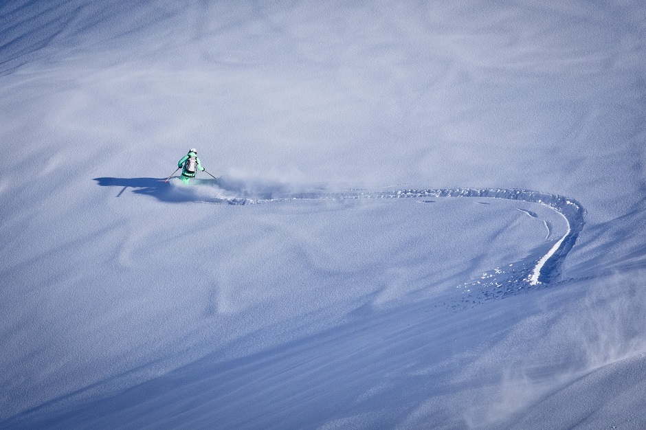 Skier carving through fresh powder in Morzine 