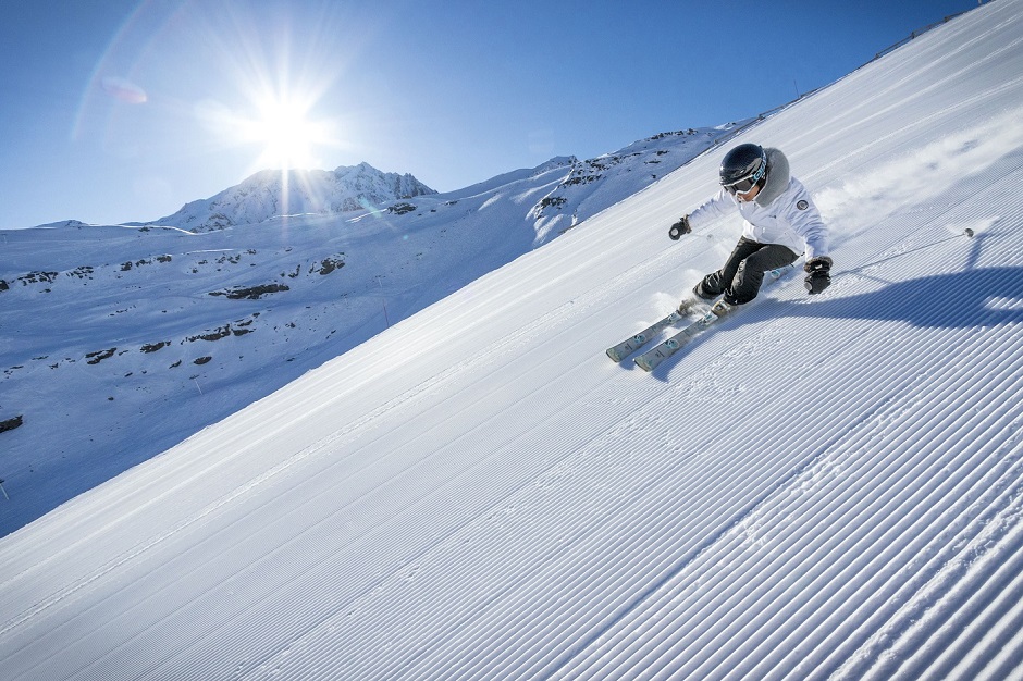 Skier on the flattened sunny slopes of Val Thorens 